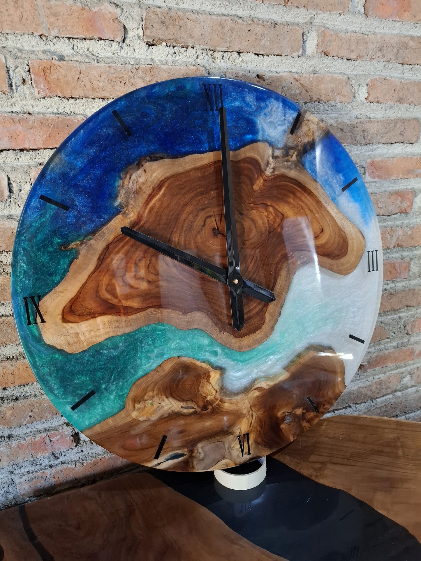 Eco-friendly wooden wall clock with vibrant ocean blue resin accents and natural grain