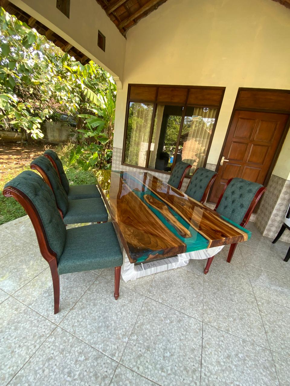 Luxury teakwood dining table with vivid turquoise resin river design, high-gloss finish