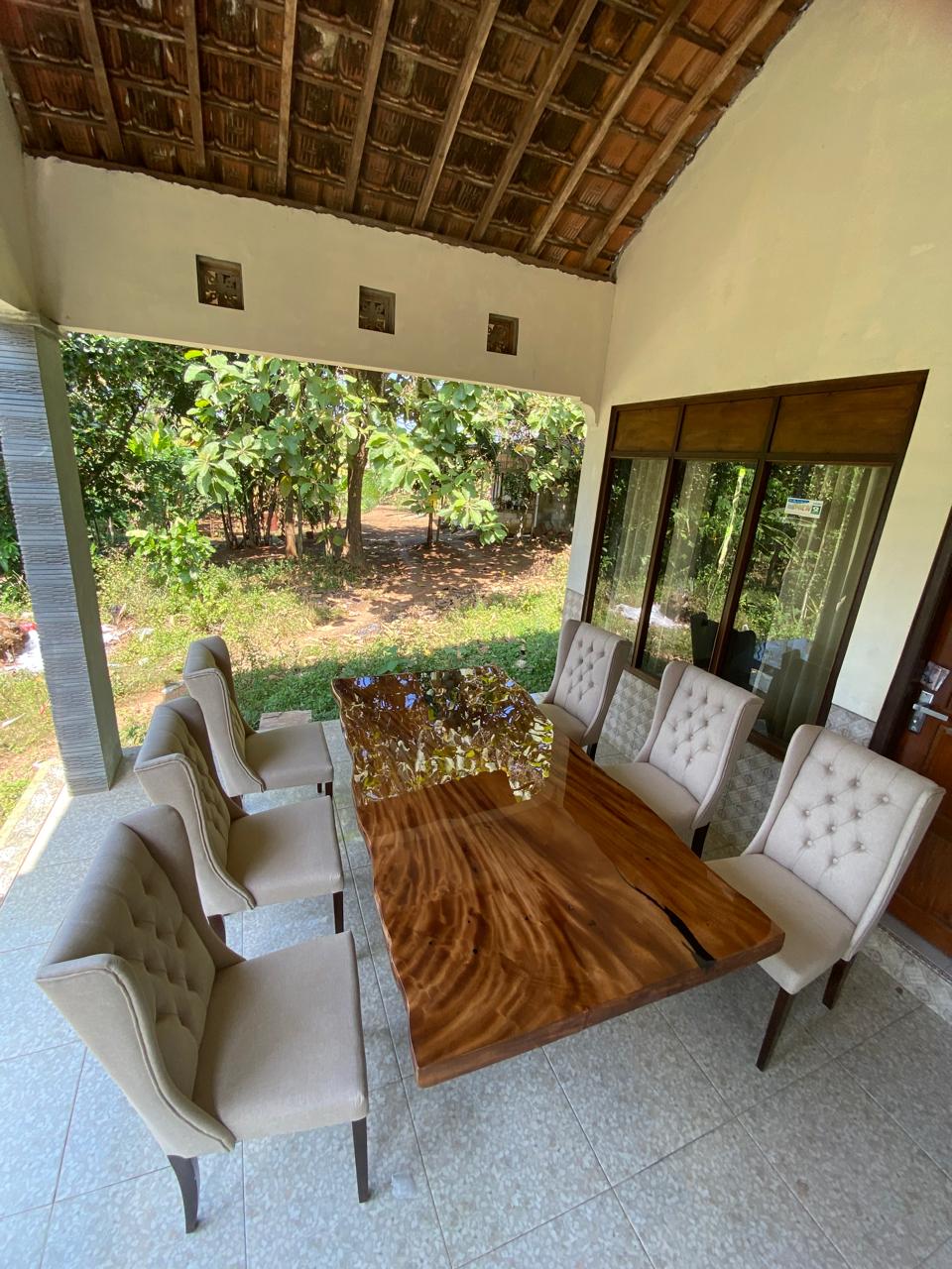 Organic dining table with natural wood grain and sleek black resin design