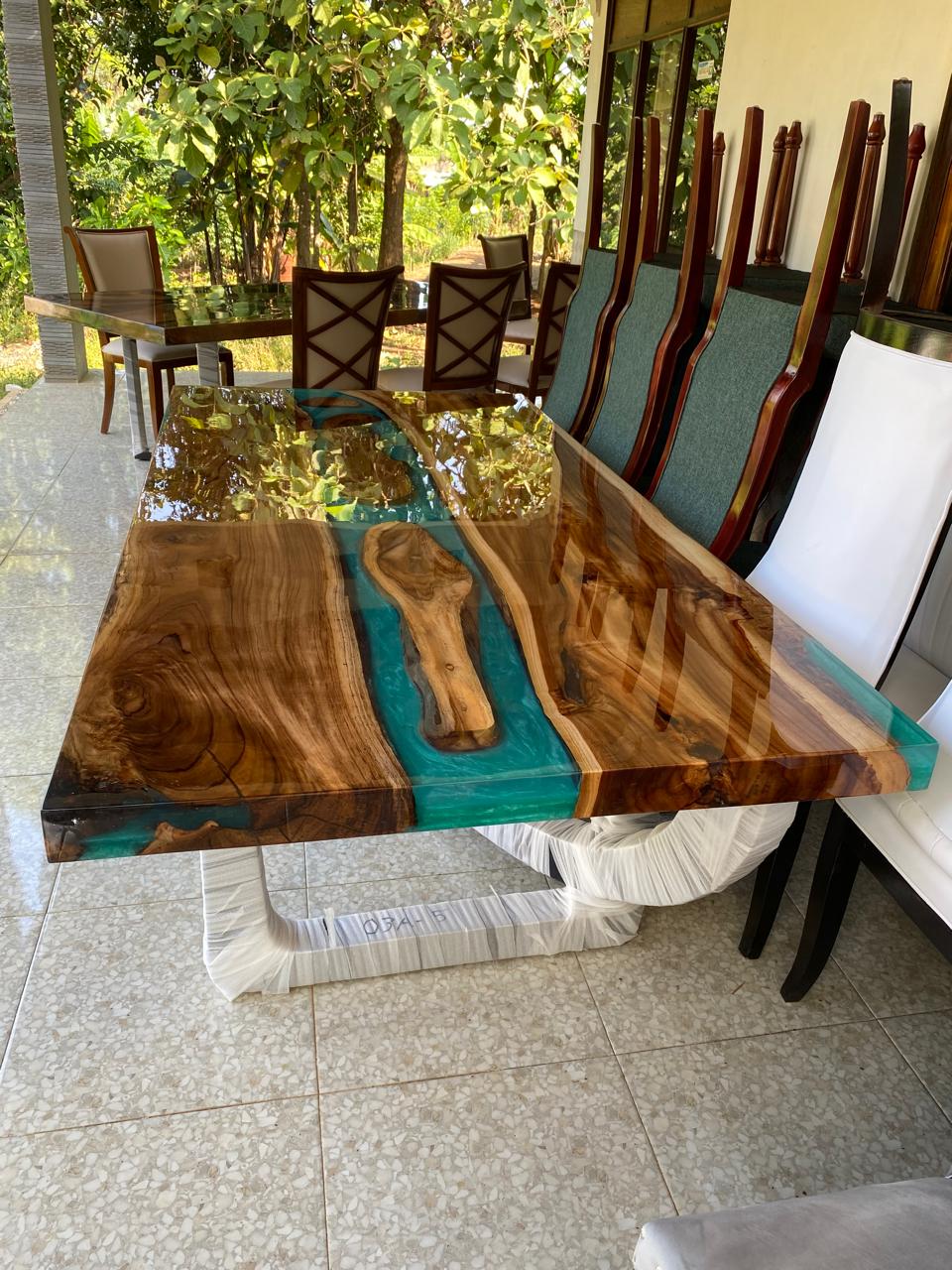 Contemporary dining table in teakwood and turquoise resin, tropical luxury design