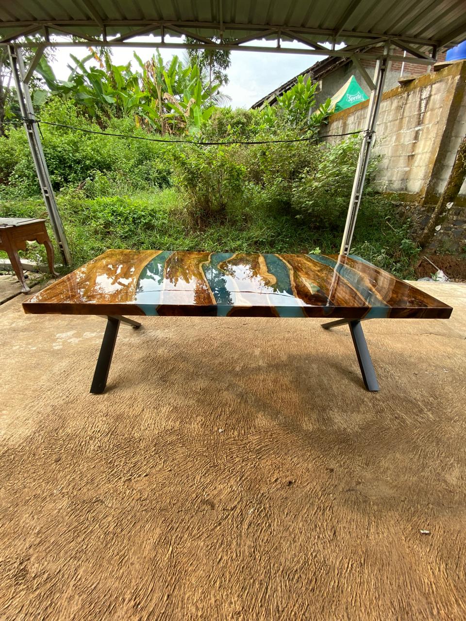 Statement dining room centerpiece table made from teakwood and vibrant resin
